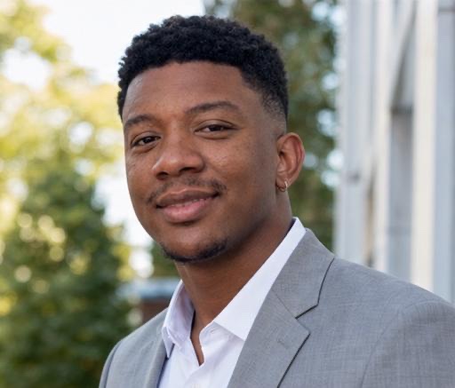 Eddie Perry wearing a gray suit jacket